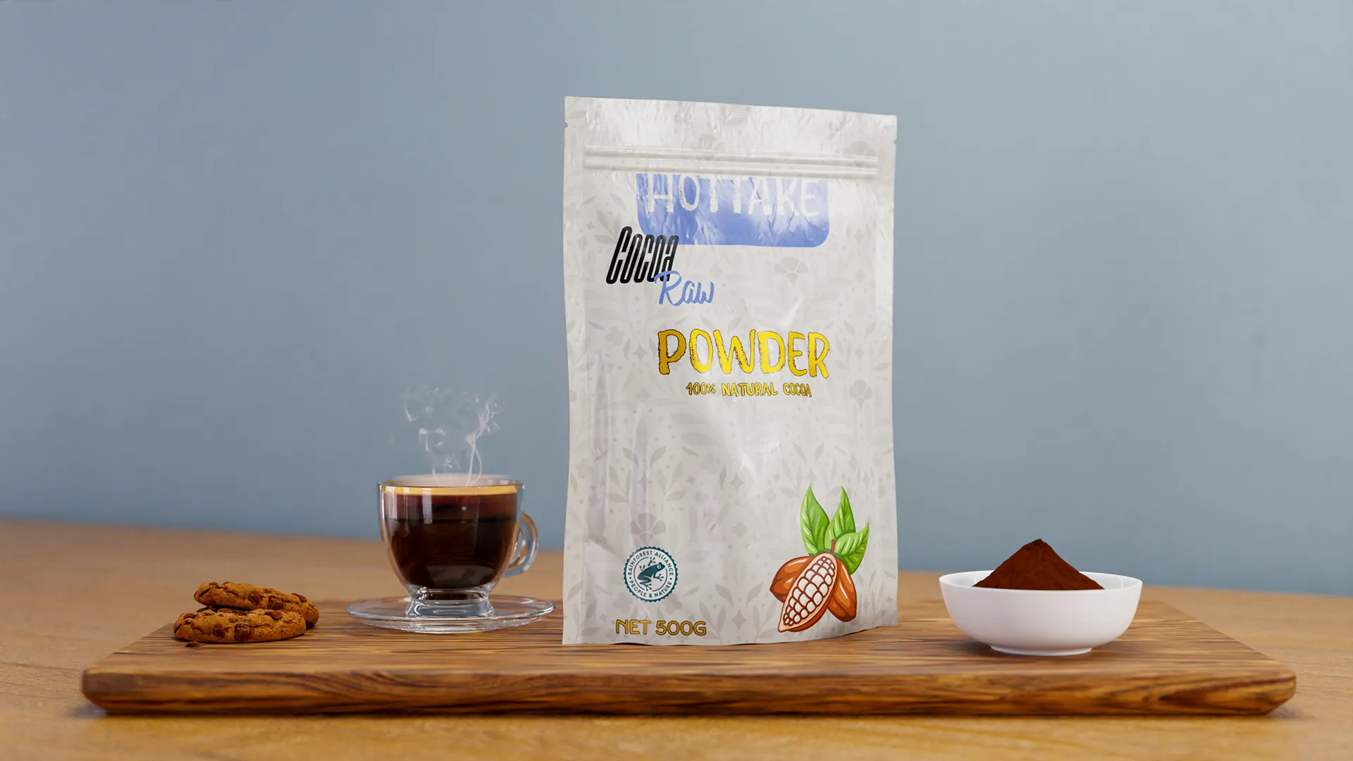 HOTTAKE cocoa product render: foil stand-up pouch on a wooden board with a coffee cup, cookies, cocoa pods, and a bowl of cocoa powder